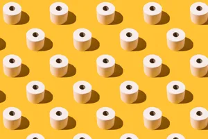 Rolls of toilet paper arranged in a neat pattern on a yellow background Rolls of toilet paper arranged in a neat pattern on a yellow background