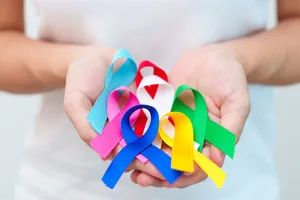 Early signs of cancer Female hands holding cancer awareness ribbons