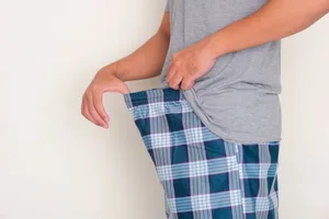 30 things you probably don’t know about your penis A main pulling the waistband of his pyjama trousers away from his body to examine his groin area