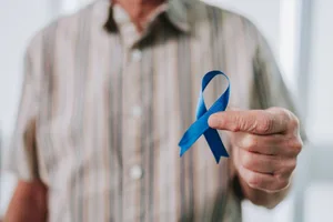 Prostate cancer An elderly man holding a prostate cancer awareness ribbon
