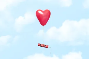 Love bomb Stick of dynamite floating across a blue sky attached to a red balloon