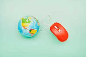 How to find the best holiday deals A red mouse is plugged into a globe against a light blue background