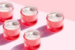 Pink pots of face cream on a pink background Pink pots of face cream on a pink background