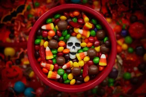 A bowl of sweets, including one skull-shaped sweet A bowl of sweets, including one skull-shaped sweet