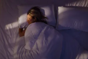 Cold bedroom for weight loss Woman sleeping in a bed