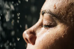 Dark showering An extreme close-up of a woman showering in the dark