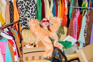 Dopamine dressing Trendy woman selling clothing online from colorful wardrobe indoors