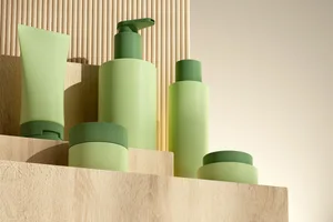 Dermatologist reveals their skincare routine A set of green cosmetic bottles and tubs arranged on wooden platforms