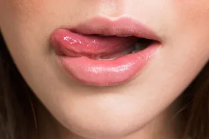tongue symptoms A close-up of a woman with her tongue out