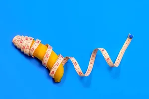 Do weight-loss jabs make your penis bigger A banana with a measuring tape wrapped around it is set against a blue background.