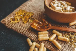 An assortment of vitamins in a wooden bowl and on a burlap mat An assortment of vitamins in a wooden bowl and on a burlap mat