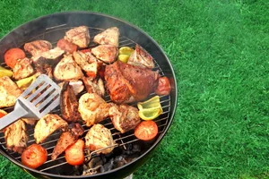 BBQ A barbecue with an assortment of meat against a green lawn
