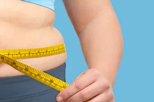 Burn belly fat fast A woman measures her stomach with a measuring tape