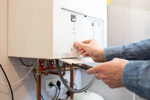 man checking boiler man checking boiler