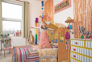 Frida’s bed was an IKEA hack as Suzy customised a toddler bed with plywood and vintage wallpaper to create a mini house at one end. Much of the artwork and accessories were handmade by Suzy too, including the Frida and Ziggy dolls, hanging pompoms, cushions and a name sign made from scrap plywood. Foil fringing, rainbow feather boas and garlands all add to the vibrant feel Bedroom makeover: 'Getting creative on a budget is my passion'