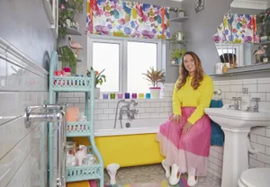 Bathroom makeover: ‘My yellow bath makes me smile’ Rather than buy an expensive pre-painted bath,
Tilly sprayed the tub herself. She also made the simple blind out of colourful fabric from Bluebellgray edged with fluorescent ribbon