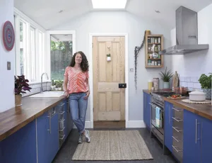 Lisa wanted to keep as much of the existing kitchen as possible to save on the makeover, so she made sure that the new blue doors would complement the existing stainless steel ones. Painting the back wall using Wilko Pearl Grey emulsion was a quick and cheap way to soften the stark white walls and add a touch of elegance Lisa wanted to keep as much of the existing kitchen as possible to save
on the makeover, so she made sure that the new blue doors would
complement the existing stainless steel ones. Painting the back wall
using Wilko Pearl Grey emulsion was a quick and cheap way to soften
the stark white walls and add a touch of elegance