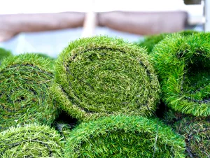 Artificial synthetic grass rolled up in a store on display for sale