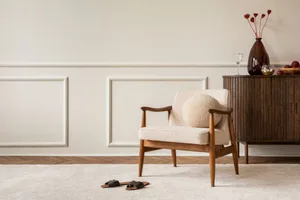 Bouclé decor A stylish, minimalist interior featuring an bouclé armchair and wooden sideboard
