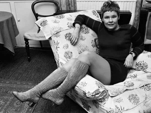 judi-dench-at-home Black and white photo of Judi Dench at home on an armchair