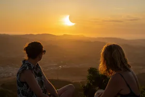 Eclipse-chasers observe a partial solar eclipse at sunset from Monte Toro viewpoint in Menorca, Spain. Credit: Sirbouman / Getty Images Eclipse-chasers observe a partial solar eclipse at sunset from Monte Toro viewpoint in Menorca, Spain. Credit: Sirbouman / Getty Images