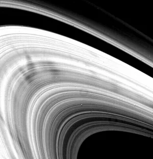 Saturn rings with ‘spoke’ features in the inner B-ring. The spokes are thought to consist of microscopic dust particles suspended by electrostatic repulsion and appear as shadows on the image. (Credit: NASA/JPL) Saturn rings with 'spoke' features in the inner B-ring. The spokes are thought to consist of microscopic dust particles suspended by electrostatic repulsion and appear as shadows on the image. (Credit: NASA/JPL)