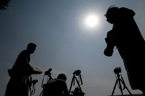 Photographers photographing the annular solar eclipse in Beijing on 21 June 2020. Photo by Noel Celis/AFP via Getty Images Photographers photographing the annular solar eclipse in Beijing on 21 June 2020. Photo by Noel Celis/AFP via Getty Images