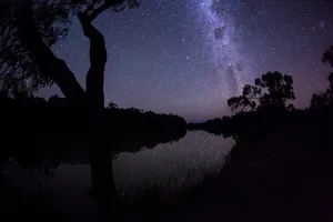 Milky Way over the Murray River. Stars reflected in the calm water. Silhouette of gum trees. Victoria. Australia. Credit: John White Photos / Getty Images Milky Way over the Murray River. Stars reflected in the calm water. Silhouette of gum trees. Victoria. Australia. Credit: John White Photos / Getty Images