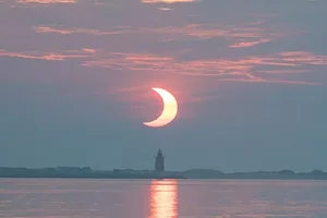 A partial solar eclipse rising behind Delaware Breakwater Lighthouse on at Lewes Beach in Delaware, USA, 10 June 2021. Credit: NASA/Aubrey Gemignani A partial solar eclipse rising behind Delaware Breakwater Lighthouse on at Lewes Beach in Delaware, USA, 10 June 2021. Credit: NASA/Aubrey Gemignani