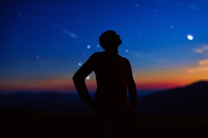 Person looking up at stars and planets in the night sky, stargazing. Credit: M-Gucci / Getty Images Person looking up at stars and planets in the night sky, stargazing. Credit: M-Gucci / Getty Images