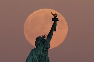 The Harvest Supermoon rises behind the Statue of Liberty in New York City, 6 October 2025. Photo by Gary Hershorn/Getty Images The Harvest Supermoon rises behind the Statue of Liberty in New York City, 6 October 2025. Photo by Gary Hershorn/Getty Images