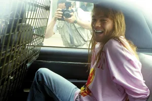 Axl Rose 1991 Guns N' Roses lead singer Axl Rose sits handcuffed in the back of a police car after he was arrested at Kennedy Airport upon his return from a European concert tour. Rose was charged with four counts of misdemeanor assault and one count of property damage stemming from a riot during a concert in 1991 in St. Louis