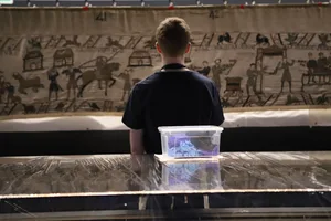 574999,TITLE:Secrets of the Bayeux Tapestry TX DATE:14-09-2026,TX WEEK:37,EMBARGOED UNTIL:01-09-2026 00:01,PEOPLE:,DESCRIPTION:Member of the Conservation team looking at the Tapestry attached to truss.,COPYRIGHT:Blast Films,CREDIT LINE:BBC/Blast Films/Bernadette Ross