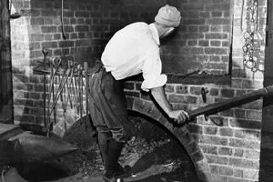 Smithy circa 1955: A re-creation of the village blacksmiths shop and a forge bellows being worked. (Photo by John Dominis/Three Lions/Getty Images)