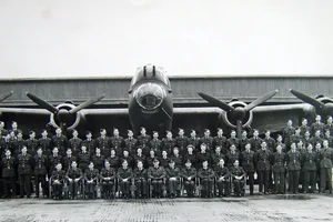 Family album 1 Black and white photograph of a group of men and women in uniform in front of a plane