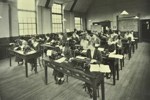 Black and white photograph of a classroom of women using typewriters in the 1920s Black and white photograph of a classroom of women using typewriters in the 1920s