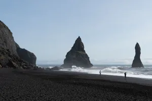 Tourists and sea stacks at Reynisfjara Beach, Iceland Tourists and sea stacks at Reynisfjara Beach, Iceland. (Photo by: Marli Miller/UCG/Universal Images Group via Getty Images)