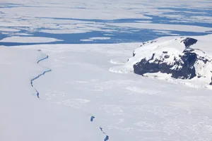 Iceberg at Coulman Island emperor penguin colony Coulman Island on the right, with the grounded iceberg on the left