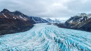 Beautiful glaciers flow through the mountains in Iceland. Aerial view and top view. Glacier