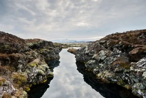 Dramatic Iceland Landscape of the Silfra Fissure Thingvellir National Park Iceland This photograph is of the Silfra where the tectonic places of North America and Eurasia meet in Thingvellir National Park, a travel destination along the Golden Circle in Iceland.