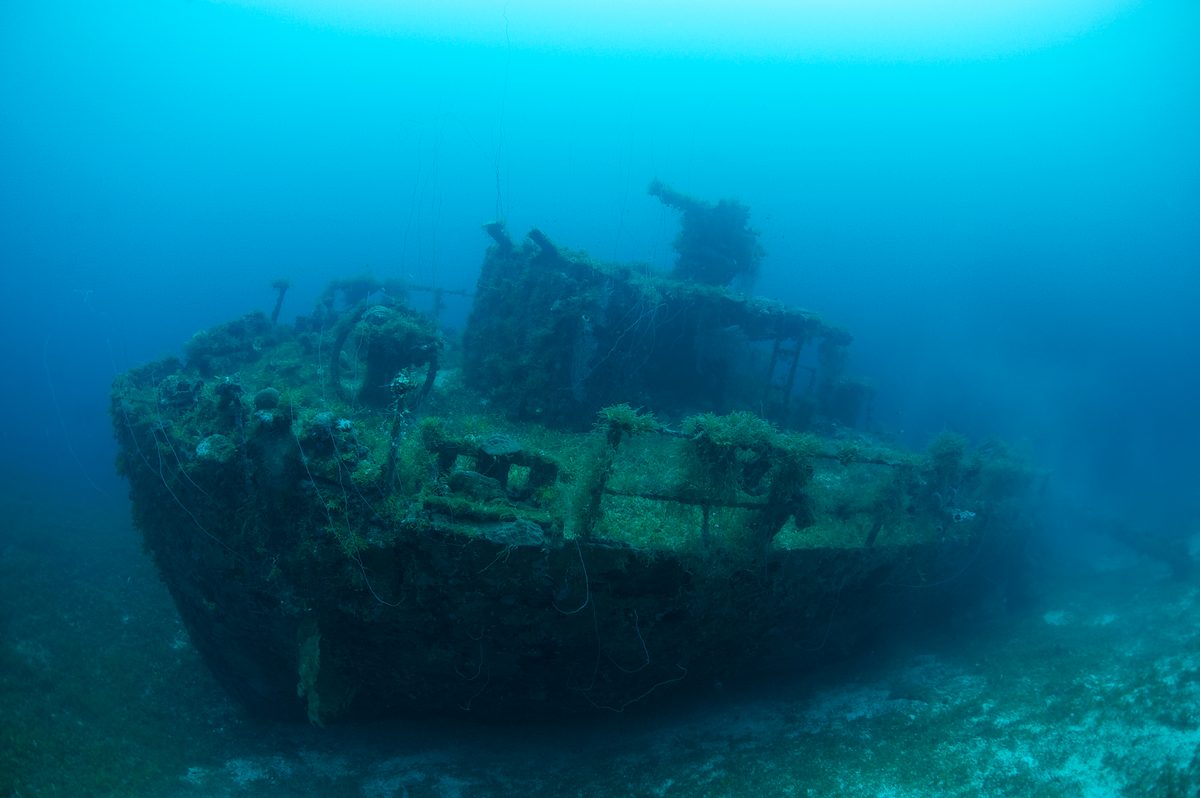 Sunken warships fill this eerie lagoon – and they're scattered with gas masks, skulls and bullet casings