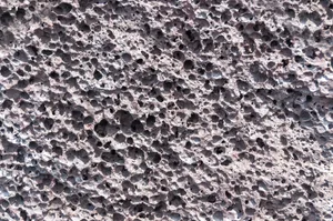 Close up of grey, deeply pitted volcanic rock on the big island of Hawaii, USA. Close up of grey pumice volcanic rock, Hawaii, USA.