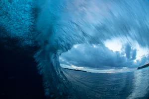 Dark Wave Looking out at a stormy sky through a breaking wave.