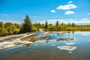View of the river in the Pinawa Dam Provincial Heritage Park against a sunny clear blue sky Pinawa, Manitoba, Canada. View of the river in the Pinawa Dam Provincial Heritage Park. The river pictured is not the Echimamish River.