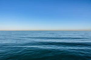 Vast expanse of blue ocean meeting a clear sky at the horizon, creating a serene and endless seascape,United States,USA View of the ocean from California