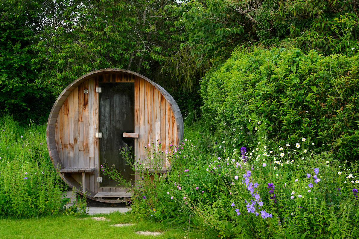 A sauna from Barrel Saunas UK in a garden designed by Emily Crowley-Wroe