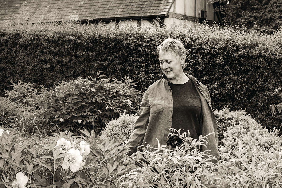 Black and white portrait of Claire Austin in a garden