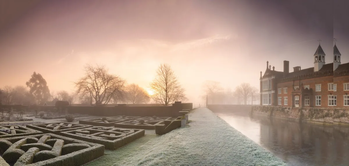 Stately home garden and house at sunrise