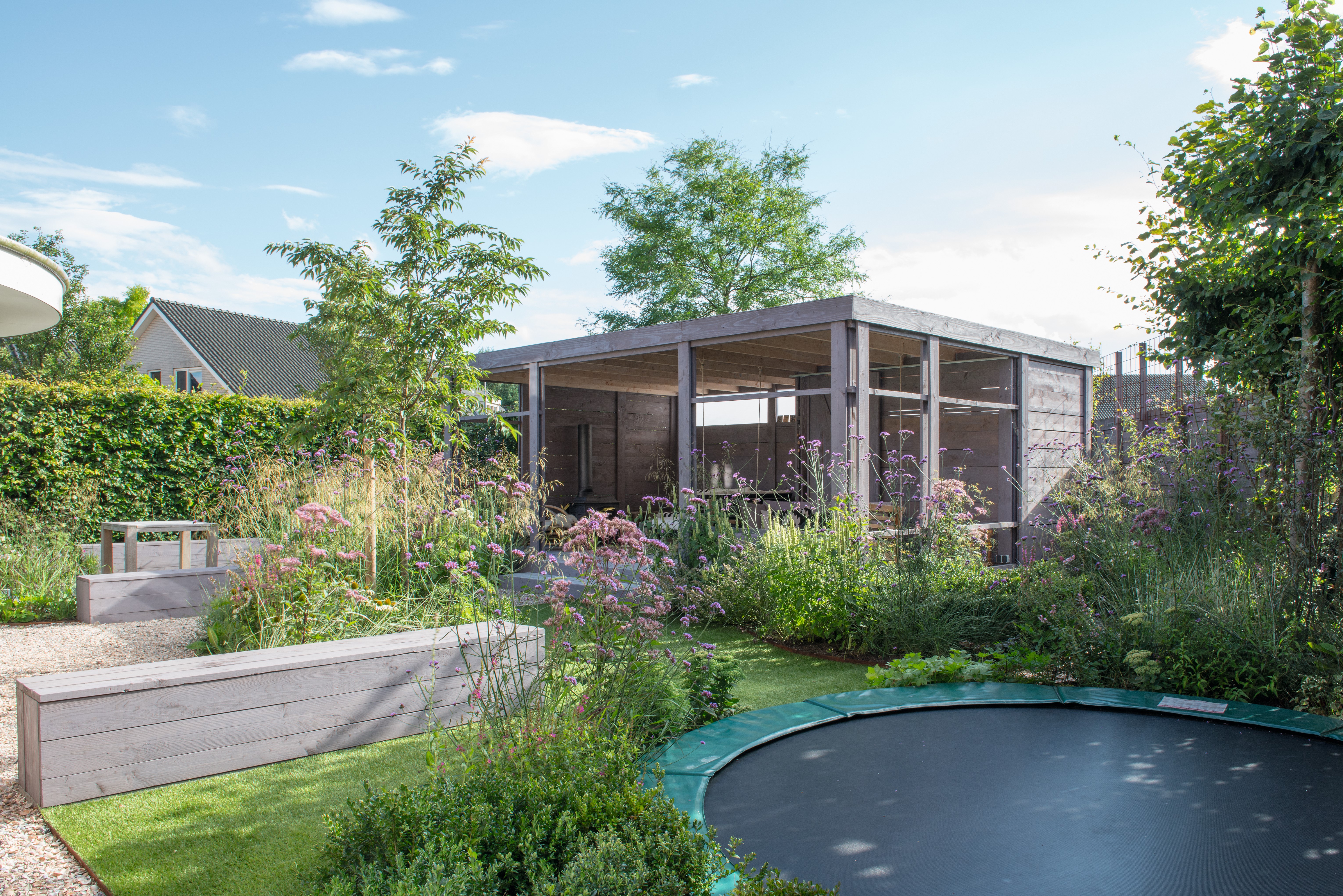 A submerged trampoline in a family garden in the Netherlands designed by Carrie Preston
