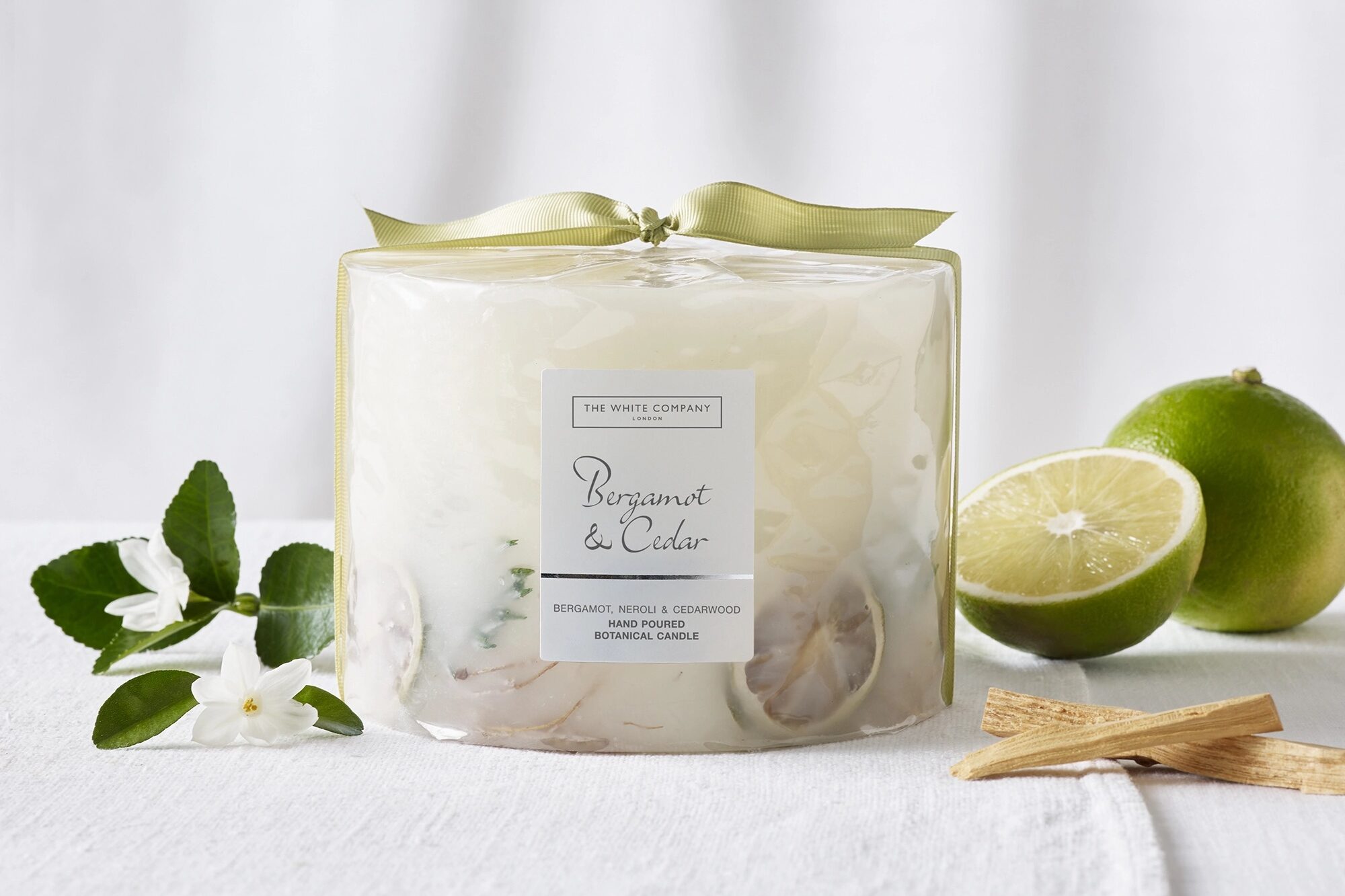 The White Company Bergamot & Cedar Botanical Candle – Large on a table
